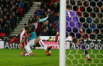Stoke City's Erik Pieters fouls West Ham United's Manuel Lanzini and referee Graham Scott consequently awards a penalty.