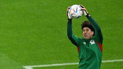 Mexico's goalkeeper #13 Guillermo Ochoa warms up ahead of the Qatar 2022 World Cup Group C football match between Saudi Arabia and Mexico at the Lusail Stadium in Lusail, north of Doha on November 30, 2022. (Photo by Pablo PORCIUNCULA / AFP)
