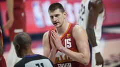 Denver Nuggets center Nikola Jokic (15) argues for a call with referee Rodney Mott (71) in the first half of Game 4 of an NBA second-round playoff series against the Phoenix Suns, Sunday, June 13, 2021, in Denver. (AP Photo/David Zalubowski)