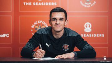 Jake Daniels signing his first professional contract at Blackpool.