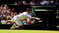 LONDON, ENGLAND - JULY 10:  Novak Djokovic of Serbia dives for a backhand in the Gentlemens Singles Semi Final match against Richard Gasquet of France during day eleven of the Wimbledon Lawn Tennis Championships at the All England Lawn Tennis and Croquet 