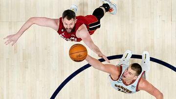 Jun 12, 2023; Denver, Colorado, USA; Miami Heat forward Kevin Love (42) reaches for the ball against Denver Nuggets center Nikola Jokic (15) during the second half in game five of the 2023 NBA Finals at Ball Arena. Mandatory Credit: Kyle Terada-USA TODAY Sports