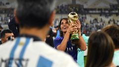 LUSAIL CITY, QATAR - DECEMBER 18: Antonela Roccuzzo, wife of Lionel Messi of Argentina, celebrates with the FIFA World Cup Qatar 2022 Winner's Trophy during the FIFA World Cup Qatar 2022 Final match between Argentina and France at Lusail Stadium on December 18, 2022 in Lusail City, Qatar. (Photo by David Ramos - FIFA/FIFA via Getty Images)