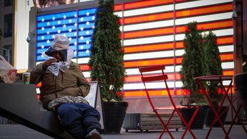 A person sits in Times Square, after New York City Mayor Eric Adams announced that homeless people deemed to be in psychiatric crisis can be involuntarily hospitalized, in Manhattan, New York City, U.S., December 1, 2022. REUTERS/Andrew Kelly
