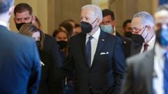 U.S. President Joe Biden walks with House Speaker Nancy Pelosi (D-CA) and Senate Majority Leader Chuck Schumer (D-NY) after paying his respects at the casket of former Senate majority leader Harry Reid.