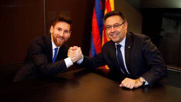 Not letting go | Barcelona's Argentine superstar Lionel Messi poses with FC Barcelona president Josep Maria Bartomeu.