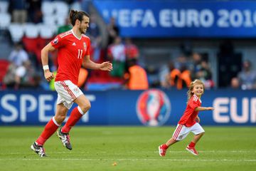 Gareth Bale of Wales celebrates his team's win with his daughter Alba Violet after the UEFA EURO 2016 round of 16 match between Wales and Northern Ireland