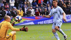 Sporting Kansas City forward Krisztian Nemeth, right, chips the ball over Montreal Impact goalkeeper Evan Bush, left, for his third goal of the match Saturday, March 30, 2019, during an MLS match in Kansas City, Mo. (Ryan Weaver/The Kansas City Star via AP)