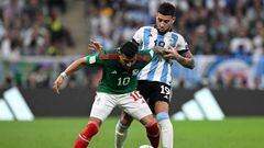 Mexico's forward #10 Alexis Vega (L) and Argentina's defender #19 Nicolas Otamendi fight for the ball during the Qatar 2022 World Cup Group C football match between Argentina and Mexico at the Lusail Stadium in Lusail, north of Doha on November 26, 2022. (Photo by Alfredo ESTRELLA / AFP) (Photo by ALFREDO ESTRELLA/AFP via Getty Images)
