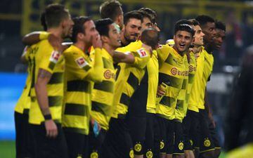 Dortmund's players celebrate after the German First division Bundesliga football match Borussia Dortmund vs Borussia Moenchengladbach in Dortmund, western Germany, on September 23,