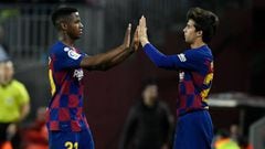 Barcelona&#039;s Spanish midfielder Riqui Puig (R) replaces Barcelona&#039;s Guinea-Bissau forward Ansu Fati (L) during the Spanish league football match between FC Barcelona and Levante UD at the Camp Nou stadium in Barcelona, on February 2, 2020. (Photo