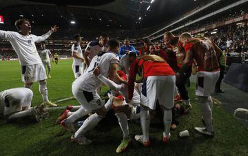 Serbia celebrate Aleksandar Mitrovic's late winner in Portugal - a goal that earned the Serbs automatic qualification at their hosts' expense.