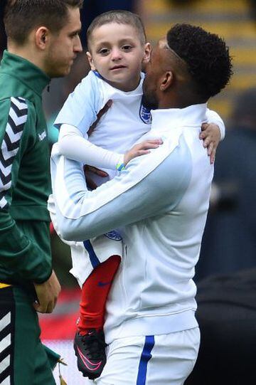 England's striker Jermain Defoe holds Bradley Lowery.
