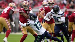 SANTA CLARA, CALIFORNIA - SEPTEMBER 18: Josh Jones #13 of the Seattle Seahawks tackles Trey Lance #5 of the San Francisco 49ers during the first quarter at Levi's Stadium on September 18, 2022 in Santa Clara, California. (Photo by Thearon W. Henderson/Getty Images)