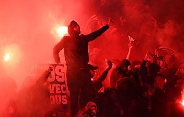 Paris Saint-Germain's supporters burn flares during the game.
