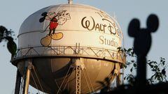 FILE PHOTO: The water tower at The Walt Disney Co., featuring the character Mickey Mouse, is seen behind a silhouette of mouse ears on the fencing surrounding the company's headquarters in Burbank, California, February 7, 2011. REUTERS/Fred Prouser/File Photo