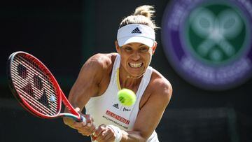 (FILES) In this file photograph taken on July 1, 2022, Germany's Angelique Kerber returns the ball to Belgium's Elise Mertens during their women's singles tennis match on the fifth day of the 2022 Wimbledon Championships at The All England Tennis Club in Wimbledon, southwest London. - Former women's world number one Angelique Kerber announced on August 24, 2022, that she is pregnant and has withdrawn from next week's US Open joking "two against one just isn't a fair competition." The 34-year-old German added that Flushing Meadow holds great memories for her. She won the title there in 2016 and, as a result, became world number one. (Photo by Adrian DENNIS / AFP) / RESTRICTED TO EDITORIAL USE