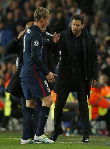 Fernando Torres is consoled by his coach as he leaves the field.