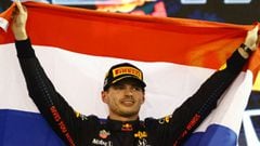 ABU DHABI, UNITED ARAB EMIRATES - DECEMBER 12: Race winner and 2021 F1 World Drivers Champion Max Verstappen of Netherlands and Red Bull Racing celebrates on the podium during the F1 Grand Prix of Abu Dhabi at Yas Marina Circuit on December 12, 2021 in Ab