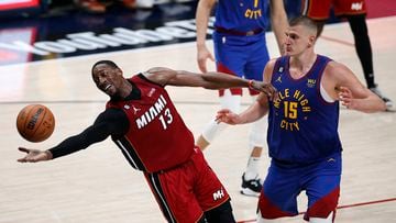 Jun 1, 2023; Denver, CO, USA; Miami Heat center Bam Adebayo (13) reaches for the ball as Denver Nuggets center Nikola Jokic (15) looks on during the fourth quarter in game one of the 2023 NBA Finals at Ball Arena. Mandatory Credit: Isaiah J. Downing-USA TODAY Sports