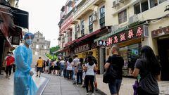FILE PHOTO: People queue for the mass coronavirus disease (COVID-19) testing near the Ruins of Saint Paul's in Macau, China June 20, 2022. REUTERS/John Mak NO RESALES. NO ARCHIVES/File Photo