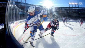 Jan 1, 2018; Queens, NY, USA; Buffalo Sabres center Jack Eichel (15) battles for the puck with New York Rangers defenseman Marc Staal (18) during the first period in the 2018 Winter Classic hockey game at Citi Field. Mandatory Credit: Brad Penner-USA TODA