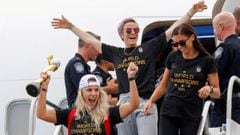 U.S. soccer players Julie Ertz (L), Megan Rapinoe (C) and Alex Morgan celebrate as they exit the plane with the Trophy for the FIFA Women&#039;s World Cup while the U.S team arrive at the Newark International Airport, in Newark, New Jersey, U.S., July 08,