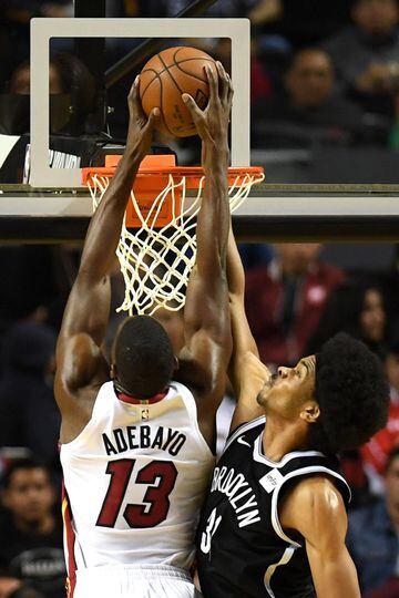 Brooklyn Nets' Jarrett Allen (R) tries to stop Miami Heat's Bam Adebayo from dunking the ball, during an NBA Global Games match at the Mexico City Arena, on December 9, 2017, in Mexico City. / AFP PHOTO / PEDRO PARDO