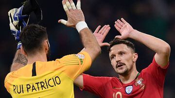 Portugal&#039;s goalkeeper Rui Patricio (L) celebrates with Portugal&#039;s defender Mario Rui at the end of the UEFA Nations League group 3 football match Italy vs Portugal at the San Siro Stadium in Milan on November 17, 2018. (Photo by Marco BERTORELLO