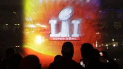 Fans watch a 3D light show as it is projected on a water spray at Super Bowl Live for the NFL Super Bowl 51 football game Tuesday, Jan. 31, 2017, in downtown Houston. (AP Photo/Eric Gay)