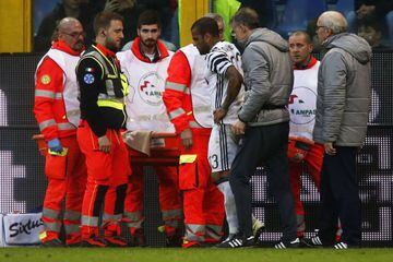 Alves (centre) leaves the pitch after suffering injury during Juve's defeat.