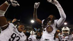 Christian Rorie #93 and Bobby Crosby #27 of the Texas State Bobcats celebrate on the sideline.