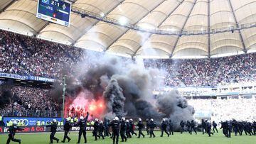 HAMBURG, GERMANY - MAY 12:  Police are seen as fans throw flares onto the pitch during the Bundesliga match between Hamburger SV and Borussia Moenchengladbach at Volksparkstadion on May 12, 2018 in Hamburg, Germany.  (Photo by Lars Baron/Bongarts/Getty Images)