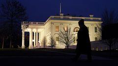 As nighttime falls, a man departs the White House in Washington, U.S., January 11, 2021.  REUTERS/Kevin Lamarque