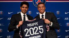 Paris Saint-Germain's CEO Nasser Al-Khelaifi (L) and French forward Kylian Mbappe (R) pose with a jersey at the end of a press conference at the Parc des Princes stadium in Paris on May 23, 2022, two days after the club won the Ligue 1 title for a record-equalling tenth time and its superstar striker Mbappe chose to sign a new contract until 2025 at PSG rather than join Real Madrid. (Photo by FRANCK FIFE / AFP) (Photo by FRANCK FIFE/AFP via Getty Images)