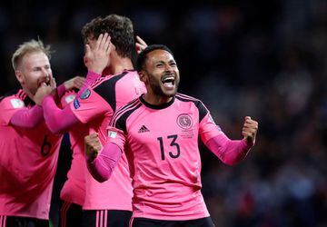 Scotland's Ikechi Anya celebrates after his side's 89th minute goal against Slovakia that keeps them in with a chance of qualifying for Russia 2018. Scotland's away kit for the qualifying campaign has been this bright pink number that's been a huge hit wi