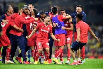 Toluca's players celebrate after defeating America during their Mexican Apertura football tournament semifinal match at the Azteca Stadium 