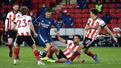 SHEFFIELD, ENGLAND - APRIL 11: Dani Ceballos of Arsenal is challenged by George Baldock of Sheffield United during the Premier League match between Sheffield United and Arsenal at Bramall Lane on April 11, 2021 in Sheffield, England. Sporting stadiums aro