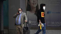 Men wear face masks in Buenos Aires, on April 17, 2020 amid the COVID-19 coronavirus pandemic. (Photo by JUAN MABROMATA / AFP)