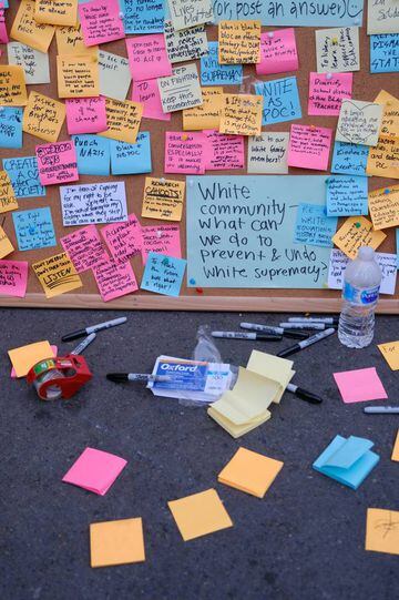 Messages are pinned to a cork board inside an area called by protesters the Capitol Hill Autonomous Zone (CHAZ) in Seattle, Washington, U.S. 11 June 2020.