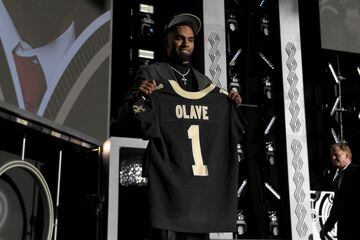 Chris Olave poses onstage after being selected 11th by the New Orleans Saints during round one of the 2022 NFL Draft.