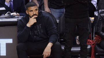 Rapper Drake, Left, looks on from his seat as the Toronto Raptors play the Golden State Warriors during the second half of Game 2 of basketball&acirc;s NBA Finals, Sunday, June 2, 2019, in Toronto. (Nathan Denette/The Canadian Press via AP)