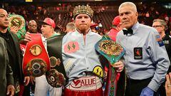 Mexican boxer Saul "Canelo" Alvarez poses with his belts and crown after defeating Kazakh boxer Gennady Golovkin to retain his undisputed super-middleweight crown at T-Mobile Arena in Las Vegas, Nevada, September 17, 2022. (Photo by Frederic J. BROWN / AFP)