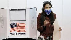 Congresswoman Alexandria Ocasio-Cortez emerges from a privacy booth with her filled ballot while participating in early voting at a polling station in The Bronx, New York City, U.S., October 25, 2020