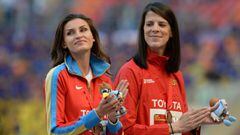 Russia&#039;s Anna Chicherova (L) and Spain&#039;s Ruth Beitia (R), both sharing third place, celebrate on the podium during the medal ceremony for the women&#039;s High Jump at the 14th IAAF World Championships in Athletics at Luzhniki Stadium in Moscow,