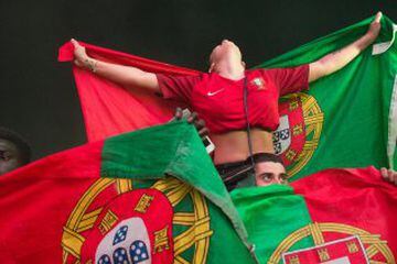 Portuguese Fans react after the Euro 2016 final football match between Portugal and France in the Eiffel Tower fan zone.inParis on July 10, 2016 in Paris, France