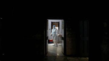 A health worker in personal protective equipment (PPE) waits at a local health centre for the next person to be tested for the coronavirus disease (COVID-19), amid the spread of the disease, in the old quarters of Delhi, India, August 14, 2020. REUTERS/Ad