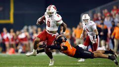 PHOENIX, ARIZONA - DECEMBER 27: Safety Jason Taylor II #25 of the Oklahoma State Cowboys tackles running back Braelon Allen #0 of the Wisconsin Badgers during the first half of the Guaranteed Rate Bowl at Chase Field on December 27, 2022 in Phoenix, Arizona.   Chris Coduto/Getty Images/AFP (Photo by Chris Coduto / GETTY IMAGES NORTH AMERICA / Getty Images via AFP)