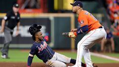 HOUSTON, TEXAS - OCTOBER 27: Ozzie Albies #1 of the Atlanta Braves slides in safely back to first base after a fly out as Yuli Gurriel #10 of the Houston Astros looks on during the eighth inning in Game Two of the World Series at Minute Maid Park on Octob