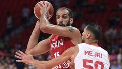Tunisia&#039;s Salah Mejri (R) attempts to block Iran&#039;s Hamed Haddadi (L) during the Basketball World Cup Group C game between Tunisia and Iran in Guangzhou on September 2, 2019. (Photo by Nicolas ASFOURI / AFP)